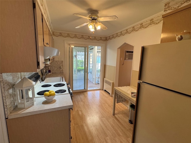 510 7th St, West Hempstead, NY 11552 - kitchen featuring freestanding refrigerator, radiator, a ceiling fan, light wood-style flooring, and range hood