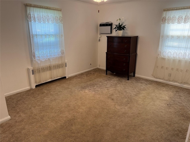 510 7th St, West Hempstead, NY 11552 - unfurnished bedroom with radiator, multiple windows, and carpet flooring