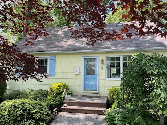 96 N Howells Point Rd, Bellport Village, NY 11713 - doorway to property with a shingled roof