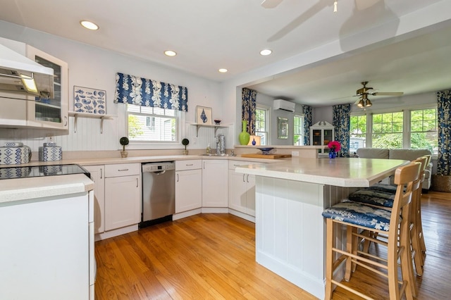 96 N Howells Point Rd, Bellport Village, NY 11713 - kitchen featuring stainless steel dishwasher, open shelves, a ceiling fan, a kitchen bar, and a peninsula
