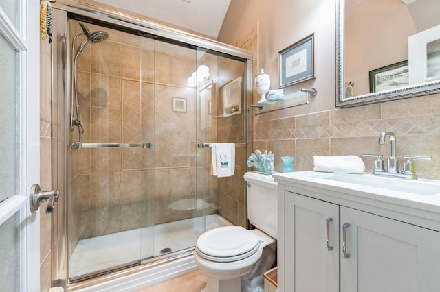 96 N Howells Point Rd, Bellport Village, NY 11713 - bathroom with toilet, vanity, a shower stall, tile walls, and a wainscoted wall