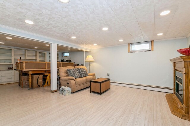 96 N Howells Point Rd, Bellport Village, NY 11713 - living room featuring a baseboard radiator, wood finished floors, ornamental molding, recessed lighting, and a glass covered fireplace