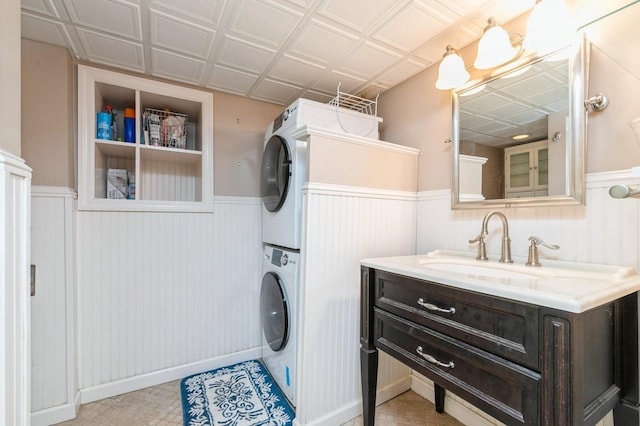 96 N Howells Point Rd, Bellport Village, NY 11713 - laundry room featuring estacked washer and dryer and wainscoting