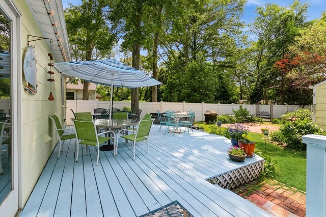 96 N Howells Point Rd, Bellport Village, NY 11713 - wooden deck with outdoor dining area and a fenced backyard