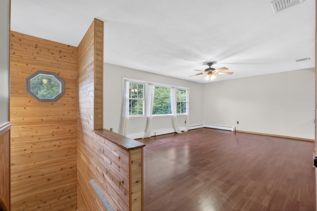 69 Crafts Rd, Carmel, NY 10512 - spare room with a ceiling fan, dark wood finished floors, and wood walls