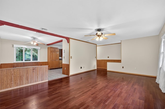 69 Crafts Rd, Carmel, NY 10512 - unfurnished living room featuring ceiling fan, wainscoting, wood finished floors, and wood walls