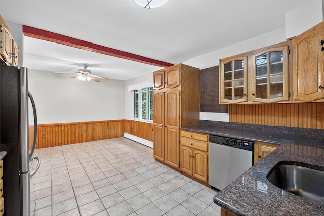 69 Crafts Rd, Carmel, NY 10512 - kitchen featuring stainless steel appliances, wood walls, wainscoting, a ceiling fan, and light tile patterned flooring