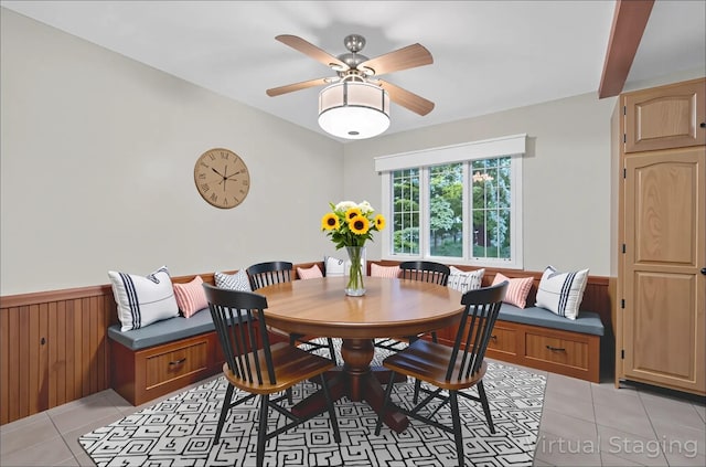 69 Crafts Rd, Carmel, NY 10512 - dining area featuring light tile patterned floors, a wainscoted wall, a ceiling fan, and wooden walls