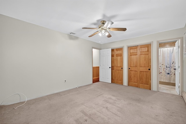 69 Crafts Rd, Carmel, NY 10512 - unfurnished bedroom featuring carpet flooring, two closets, connected bathroom, and a ceiling fan
