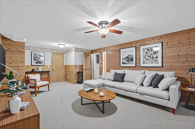69 Crafts Rd, Carmel, NY 10512 - living area with wooden walls, carpet floors, and a ceiling fan