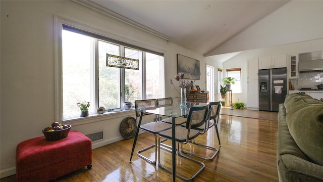 1651 201st St, Bayside, NY 11360 - dining area with plenty of natural light, wood finished floors, lofted ceiling, and baseboards