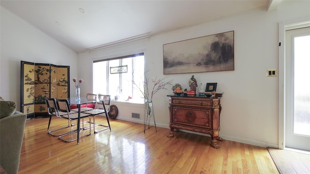 1651 201st St, Bayside, NY 11360 - dining space with lofted ceiling, healthy amount of natural light, wood finished floors, and baseboards