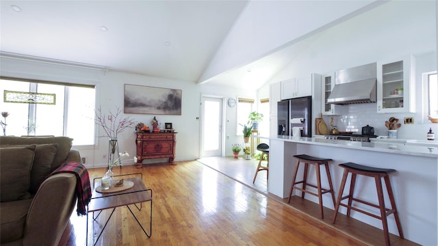 1651 201st St, Bayside, NY 11360 - living area with light wood-style flooring, baseboards, and high vaulted ceiling