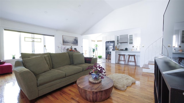 1651 201st St, Bayside, NY 11360 - living room with high vaulted ceiling and light wood-style flooring
