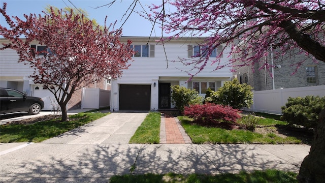 1651 201st St, Bayside, NY 11360 - view of front facade featuring driveway and an attached garage