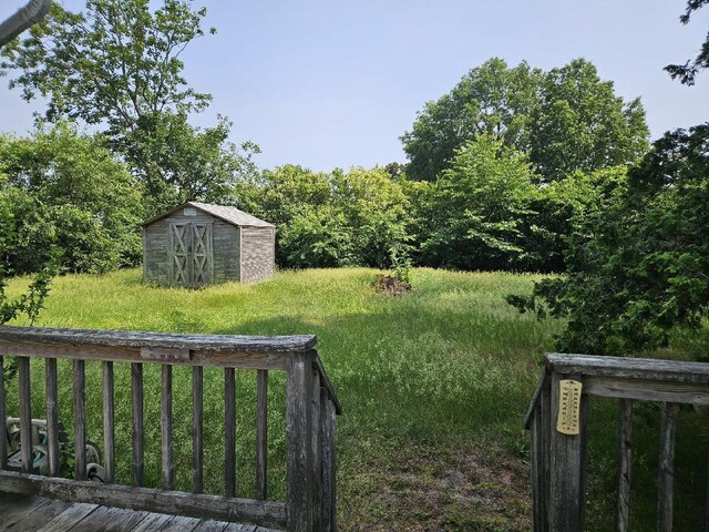 209 Loop Dr, Sayville, NY 11782 - view of grassy yard with a storage unit