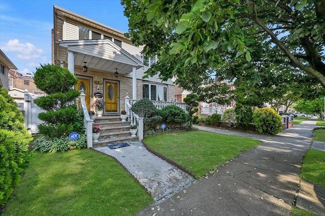 4539 192nd St, Flushing, NY 11358 - view of front of house featuring a front yard and brick siding