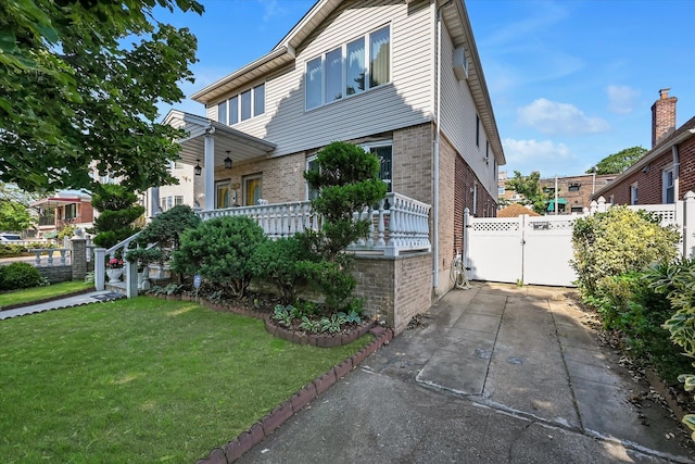 4539 192nd St, Flushing, NY 11358 - view of front facade with brick siding and a gate