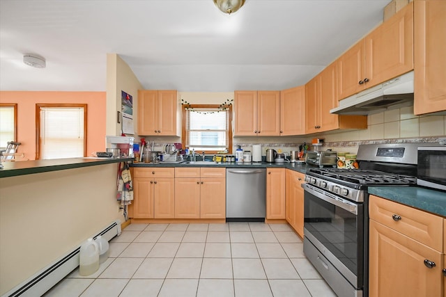 4539 192nd St, Flushing, NY 11358 - kitchen with stainless steel appliances, light brown cabinetry, dark countertops, under cabinet range hood, and baseboard heating