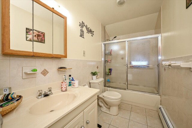 4539 192nd St, Flushing, NY 11358 - bathroom with vanity, tile patterned floors, baseboard heating, tile walls, and toilet