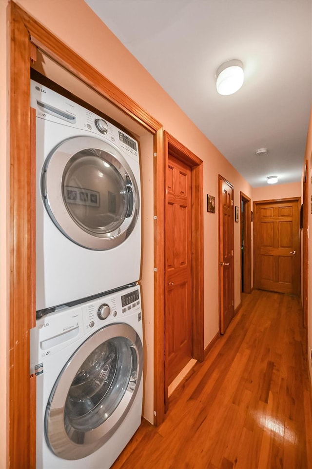 4539 192nd St, Flushing, NY 11358 - laundry area with estacked washer and dryer and wood finished floors