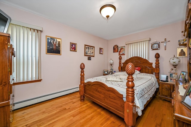 4539 192nd St, Flushing, NY 11358 - bedroom with a baseboard radiator and wood finished floors