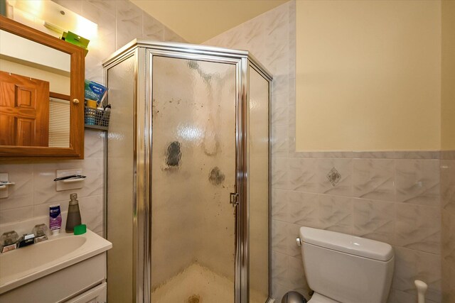 4539 192nd St, Flushing, NY 11358 - full bathroom with tile walls, vanity, toilet, and a stall shower