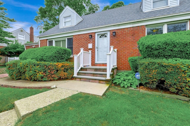 7 Dawn Dr, East Northport, NY 11731 - view of front of property with brick siding, a shingled roof, and a front lawn