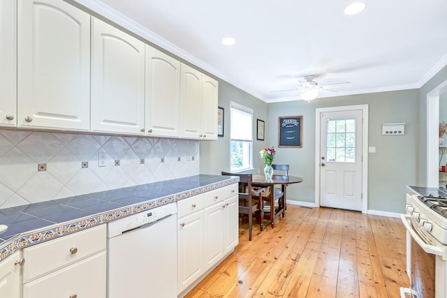 7 Dawn Dr, East Northport, NY 11731 - kitchen featuring white appliances, light wood-style floors, baseboards, decorative backsplash, and white cabinets