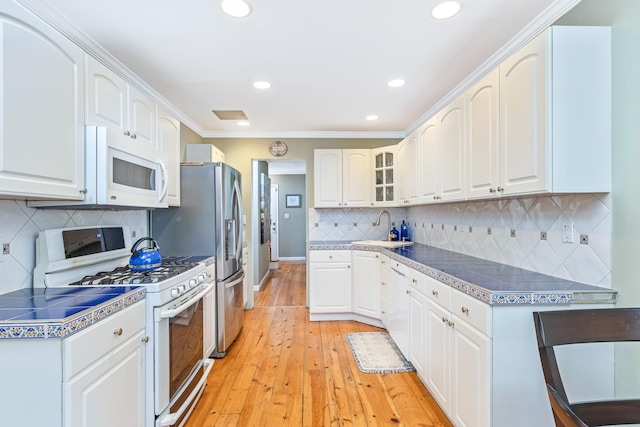 7 Dawn Dr, East Northport, NY 11731 - kitchen with white appliances, a sink, recessed lighting, white cabinetry, and light wood-style floors