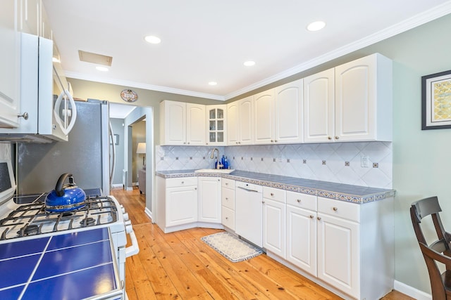 7 Dawn Dr, East Northport, NY 11731 - kitchen with white appliances, a sink, light wood-style floors, tasteful backsplash, and white cabinetry