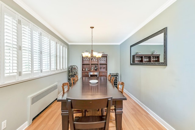 7 Dawn Dr, East Northport, NY 11731 - dining area featuring radiator heating unit, wood finished floors, crown molding, a chandelier, and baseboards