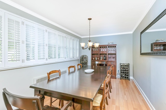 7 Dawn Dr, East Northport, NY 11731 - dining area with a chandelier, ornamental molding, light wood-style floors, plenty of natural light, and baseboards