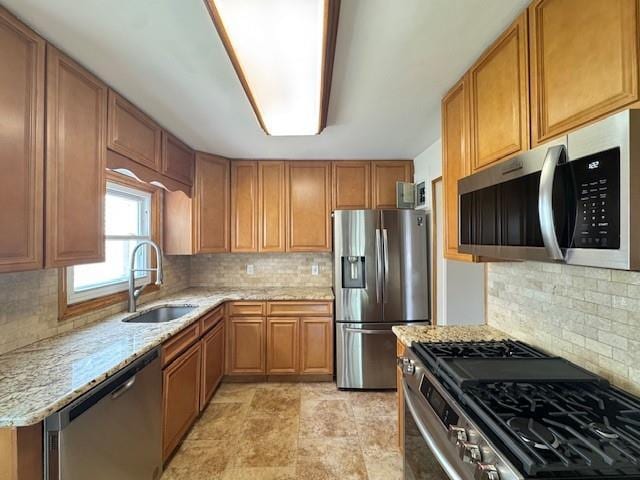 20817 15th Rd, Bayside, NY 11360 - kitchen featuring appliances with stainless steel finishes, a sink, light stone countertops, and decorative backsplash