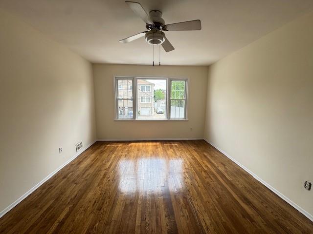 20817 15th Rd, Bayside, NY 11360 - unfurnished room with ceiling fan, dark wood-style flooring, and baseboards