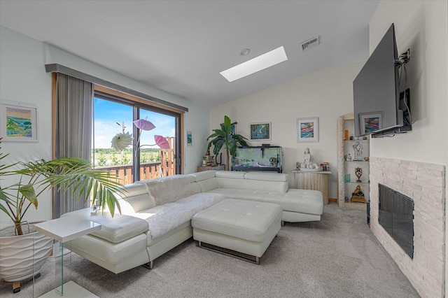 1 Anchorage Way Unit 704, Freeport, NY 11520 - living area featuring a skylight, lofted ceiling, a fireplace, and light carpet