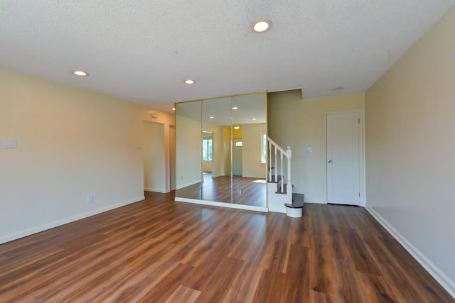 162-29 95th St, Howard Beach, NY 11414 - unfurnished living room with wood finished floors, stairway, a textured ceiling, and recessed lighting