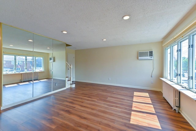 162-29 95th St, Howard Beach, NY 11414 - unfurnished room with radiator heating unit, a textured ceiling, wood finished floors, stairs, and plenty of natural light