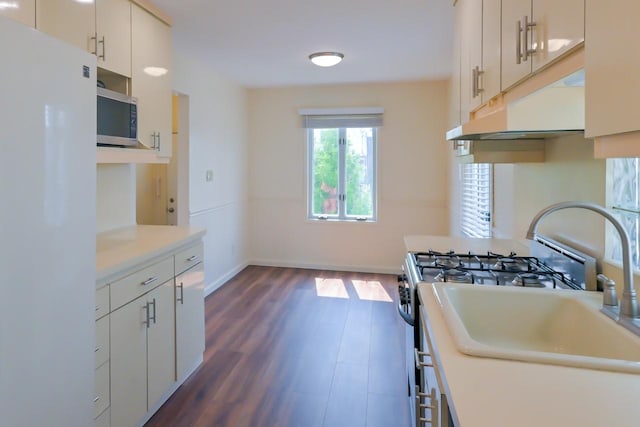 162-29 95th St, Howard Beach, NY 11414 - kitchen featuring freestanding refrigerator, stainless steel microwave, light countertops, range with gas stovetop, and dark wood-style flooring