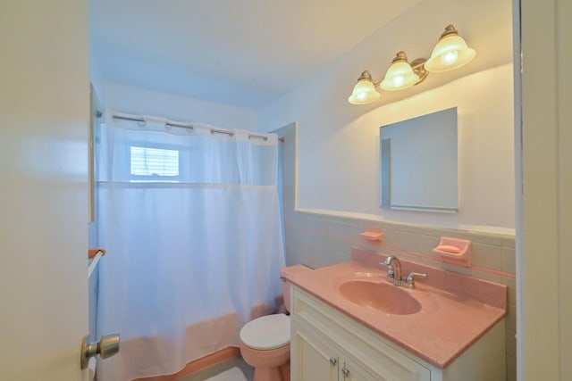 162-29 95th St, Howard Beach, NY 11414 - bathroom featuring vanity, shower / tub combo, tile walls, and a wainscoted wall