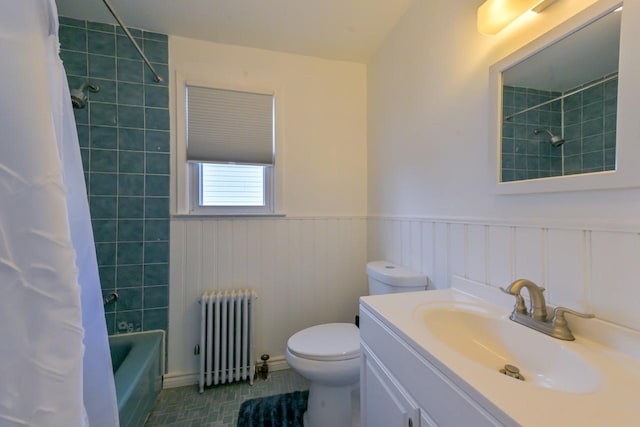 162-29 95th St, Howard Beach, NY 11414 - bathroom featuring radiator heating unit, vanity, shower / bath combo with shower curtain, wainscoting, and tile patterned floors