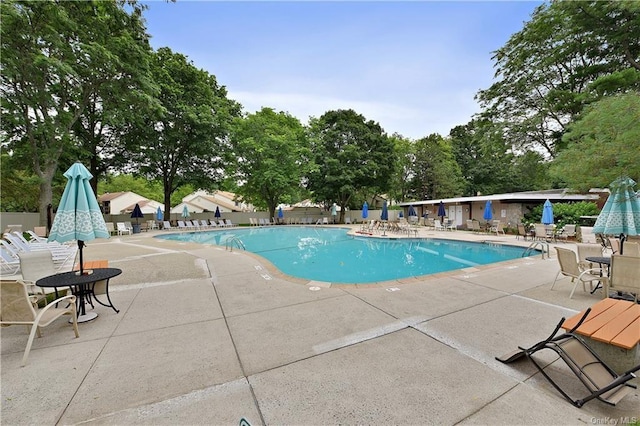 20 Hastings Ct Unit A, Jefferson Valley, NY 10598 - community pool with a patio and view of scattered trees