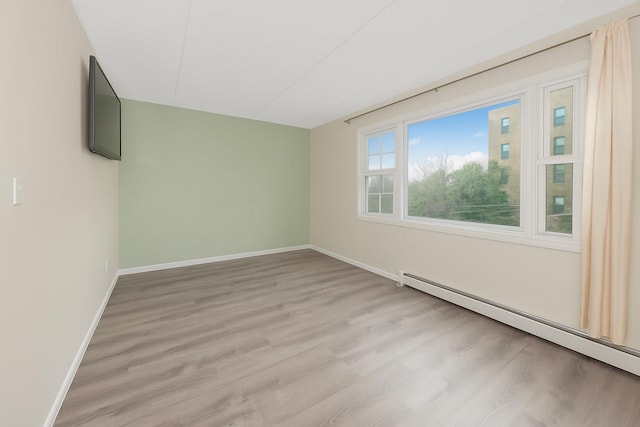 1321 Lafayette Ave, Bronx, NY 10474 - unfurnished room featuring baseboard heating, baseboards, and light wood-style flooring