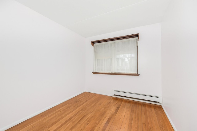 1321 Lafayette Ave, Bronx, NY 10474 - empty room featuring a baseboard radiator, hardwood / wood-style floors, and baseboards