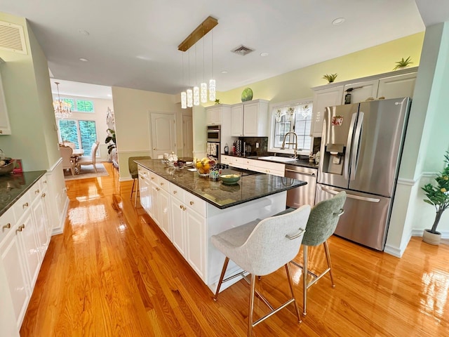 91 Harbor Rd, Head Of The Harbor, NY 11780 - kitchen featuring appliances with stainless steel finishes, a sink, a chandelier, healthy amount of natural light, and recessed lighting