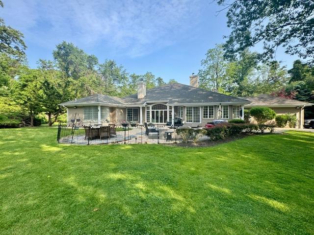 91 Harbor Rd, Head Of The Harbor, NY 11780 - back of property with a patio, a lawn, and a chimney