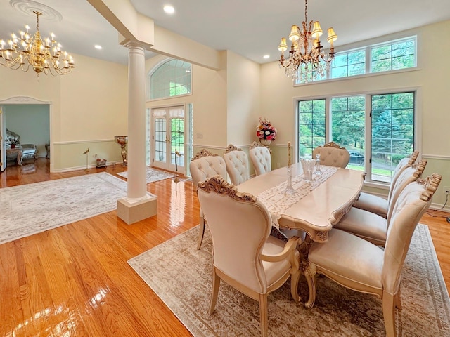 91 Harbor Rd, Head Of The Harbor, NY 11780 - dining area featuring a chandelier, decorative columns, wood finished floors, recessed lighting, and baseboards