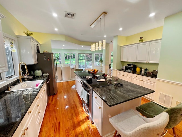 91 Harbor Rd, Head Of The Harbor, NY 11780 - kitchen featuring stainless steel electric stove, a sink, white cabinets, light wood-type flooring, and a center island
