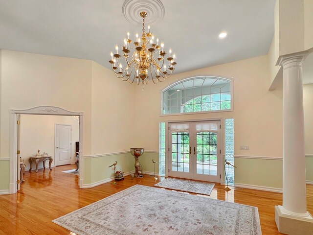 91 Harbor Rd, Head Of The Harbor, NY 11780 - foyer entrance featuring ornate columns, french doors, light wood-style flooring, baseboards, and a towering ceiling