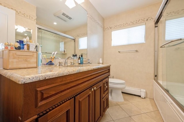 696 Byron Ave, Franklin Square, NY 11010 - full bath with a baseboard heating unit, vanity, toilet, tile patterned flooring, and bath / shower combo with glass door